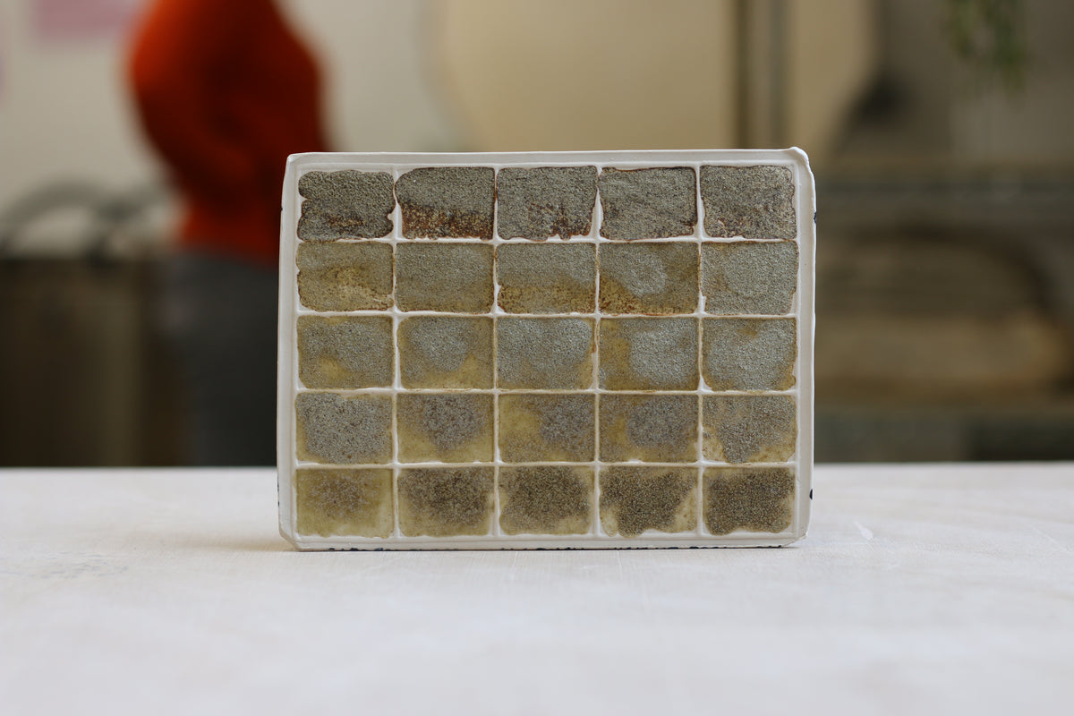 A flat slab tile carrying a ceramic glaze blend by Steven Sales
